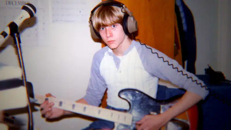 Kurt Cobain as a young boy playing guitar